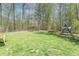Spacious backyard featuring a trampoline, playset, and firepit, perfect for outdoor enjoyment at 2985 Little Hurricane Rd, Martinsville, IN 46151