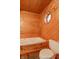 Bathroom with a wooden-paneled walls, a toilet, and a hot tub placed beneath a small window at 2985 Little Hurricane Rd, Martinsville, IN 46151