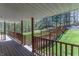 Inviting deck featuring wood railings and flooring, surrounded by a lush forest landscape at 2985 Little Hurricane Rd, Martinsville, IN 46151