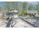 Spacious property featuring a detached garage with driveway and home with a large deck and mature trees at 2985 Little Hurricane Rd, Martinsville, IN 46151