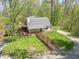 Inviting home featuring a large yard, multiple decks, and a charming walkway surrounded by lush greenery at 2985 Little Hurricane Rd, Martinsville, IN 46151
