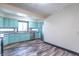 Bright kitchen with stainless appliances, modern flooring, and light blue cabinets at 2985 Little Hurricane Rd, Martinsville, IN 46151