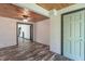 A living room with wooden ceiling and paneled walls, and gray trim around the door frames at 2985 Little Hurricane Rd, Martinsville, IN 46151