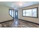 Stylish living room with wood floors, a decorative front door, and a bright window at 2985 Little Hurricane Rd, Martinsville, IN 46151
