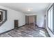 An angled view of a living room with a large window that looks onto a green yard and wood flooring at 2985 Little Hurricane Rd, Martinsville, IN 46151