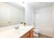 Well-lit bathroom with a single vanity, tile flooring and a shower-tub combo at 3006 Wildcat Ln, Indianapolis, IN 46203