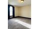 Bedroom with carpet flooring, a large window with dark curtains and baseboard trim at 301 N Main St, Franklin, IN 46131