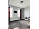Bedroom featuring carpet flooring, two windows with red curtains and a mounted TV at 301 N Main St, Franklin, IN 46131
