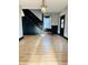Open entryway featuring hardwood floors, black painted trim and stairs at 301 N Main St, Franklin, IN 46131