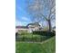 Exterior view of the house showcasing the well-maintained lawn and fence at 301 N Main St, Franklin, IN 46131