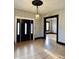 Inviting foyer featuring hardwood floors, a stylish chandelier, and an entry way to another room at 301 N Main St, Franklin, IN 46131