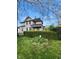View of the home's exterior, with a manicured hedge and a glimpse of the yard at 301 N Main St, Franklin, IN 46131