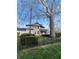 Exterior view of the house showcasing the well-maintained lawn and fence at 301 N Main St, Franklin, IN 46131