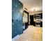 Well-lit kitchen featuring black cabinetry, stainless steel appliances, and a unique butterfly-themed accent wall at 301 N Main St, Franklin, IN 46131