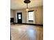 Bright and airy living room with a fresh coat of paint, new floors, and a classic light fixture at 301 N Main St, Franklin, IN 46131
