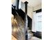 Staircase with dark wood trim, leading to the upper floor, with carpeted treads at 301 N Main St, Franklin, IN 46131
