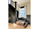 View of the staircase showcasing the black-painted wood trim and large window at 301 N Main St, Franklin, IN 46131