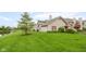 Spacious backyard with lush green lawn and mature tree, perfect for outdoor enjoyment and relaxation by the water at , Indianapolis, IN 46203