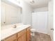 Bathroom featuring wood-look cabinets, laminate floor, single sink, and shower at , Indianapolis, IN 46203