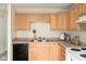 Practical kitchen featuring bright wood cabinets, black appliances, and a functional layout at , Indianapolis, IN 46203