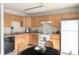 Functional kitchen with light wood cabinets, modern appliances, and a cozy dining area at , Indianapolis, IN 46203