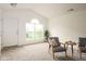 Comfortable living room featuring vaulted ceilings, neutral carpet, and ample natural light from a large window at , Indianapolis, IN 46203