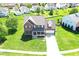 Aerial view of a traditional brick home with a manicured lawn in a residential neighborhood at 3101 Woodhaven Way, Bargersville, IN 46106