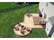 Overhead shot of backyard with patio, fire pit, seating, deck, and green grass at 3101 Woodhaven Way, Bargersville, IN 46106