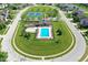 Overhead view of a community pool, playground, and tennis courts surrounded by residential homes and manicured green spaces at 3101 Woodhaven Way, Bargersville, IN 46106