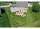 Aerial view of a fenced backyard featuring a patio, fire pit, and outdoor seating at 3101 Woodhaven Way, Bargersville, IN 46106