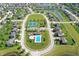 Aerial photo showcasing community with pool, clubhouse, tennis courts, surrounded by homes and complemented by lush green landscape at 3101 Woodhaven Way, Bargersville, IN 46106