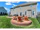 Backyard showcases a beautiful patio with a fire pit, seating area, grill and a well-manicured lawn at 3101 Woodhaven Way, Bargersville, IN 46106