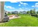 Spacious backyard with a patio, seating area, fire pit, and well-maintained lawn at 3101 Woodhaven Way, Bargersville, IN 46106