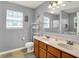 Bright bathroom showcasing a double sink vanity, large mirror, and natural light at 3101 Woodhaven Way, Bargersville, IN 46106