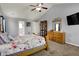 Comfortable bedroom featuring carpet floors, a ceiling fan, a large bed, and an en suite bathroom at 3101 Woodhaven Way, Bargersville, IN 46106