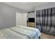 Cozy bedroom with neutral walls, carpet flooring, and ample natural light from a window with blue curtains at 3101 Woodhaven Way, Bargersville, IN 46106