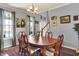 A dining room is brightened by the natural light with hardwood floors and a staircase in the background at 3101 Woodhaven Way, Bargersville, IN 46106