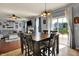 Bright dining area with a large table and chairs, flowing into the living area with lots of natural light at 3101 Woodhaven Way, Bargersville, IN 46106