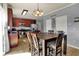 Eat-in kitchen has a large table with hardwood floors, an island, and stainless steel appliances at 3101 Woodhaven Way, Bargersville, IN 46106