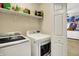 Convenient laundry room featuring modern washer and dryer units and shelving for organized storage at 3101 Woodhaven Way, Bargersville, IN 46106