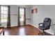 Well lit living space featuring hardwood floors, neutral walls, and bright windows with decorative curtains at 3101 Woodhaven Way, Bargersville, IN 46106
