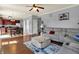 Inviting living room featuring hardwood floors, a gray sofa, and an adjacent eat-in kitchen at 3101 Woodhaven Way, Bargersville, IN 46106