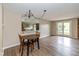 Casual dining area with wood table, two chairs, and modern chandelier fixture at 3113 Sandpiper N Dr, Indianapolis, IN 46268