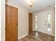 Charming home entryway with wood-look flooring, white front door, and sidelight window at 3113 Sandpiper N Dr, Indianapolis, IN 46268
