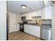 Modern kitchen featuring stainless steel appliances, stone countertops and sleek white cabinets at 3113 Sandpiper N Dr, Indianapolis, IN 46268