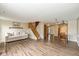 Inviting living room with hardwood floors, stairs to second floor and an abundance of natural light at 3113 Sandpiper N Dr, Indianapolis, IN 46268