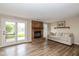 Inviting living room features a cozy brick fireplace and sliding glass door with lake view at 3113 Sandpiper N Dr, Indianapolis, IN 46268