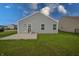 Home featuring a large backyard, a small patio, and a house with gray vinyl siding at 3367 Rolling Knoll Ln, Columbus, IN 47201