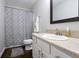 Cozy bathroom featuring wood-look floors, a shower-tub combo, and a vanity with light countertops at 3367 Rolling Knoll Ln, Columbus, IN 47201