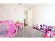 bedroom features neutral walls, plush carpet, and a variety of play furniture and toys at 3367 Rolling Knoll Ln, Columbus, IN 47201